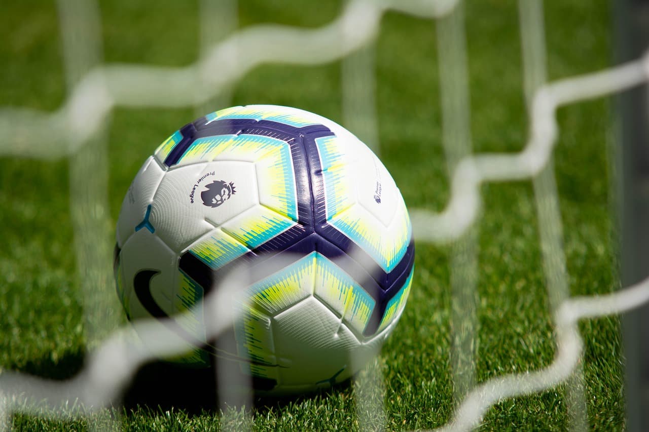 Footballs on a green pitch